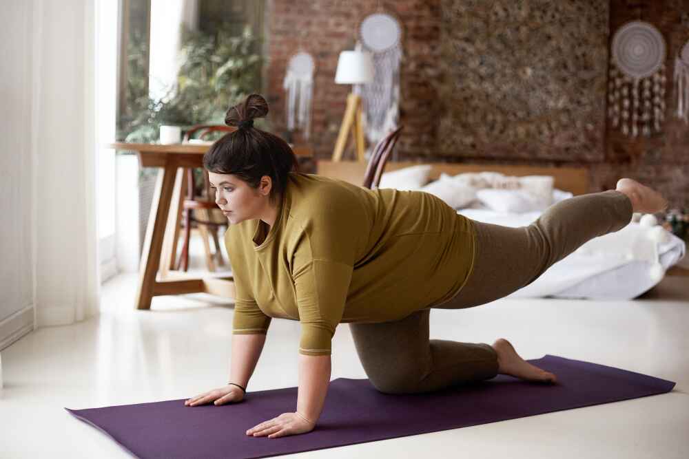 A Woman Practicing Yoga to Prevent Weight Gain